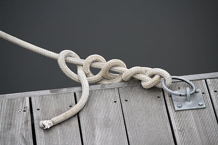 close up photo of white rope tie on buckle