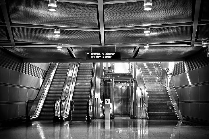grayscale photo of empty escalator