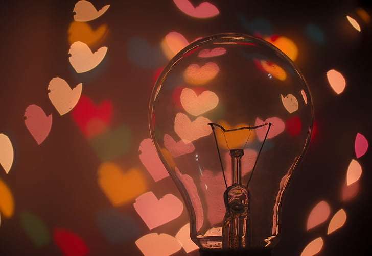 closeup photography of clear glass bulb with heart backgrounds