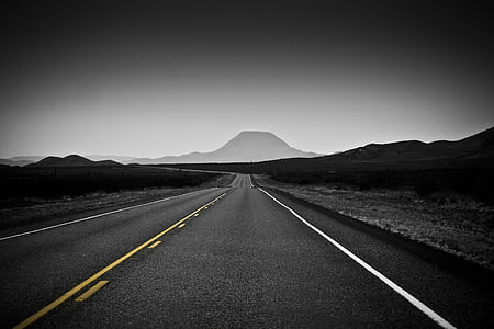 gray concrete road near mountain