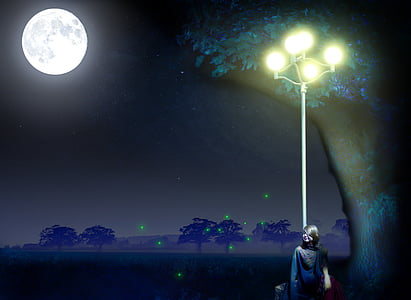 woman standing beside lamp post during nighttime
