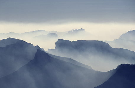 foggy mountains under white sky