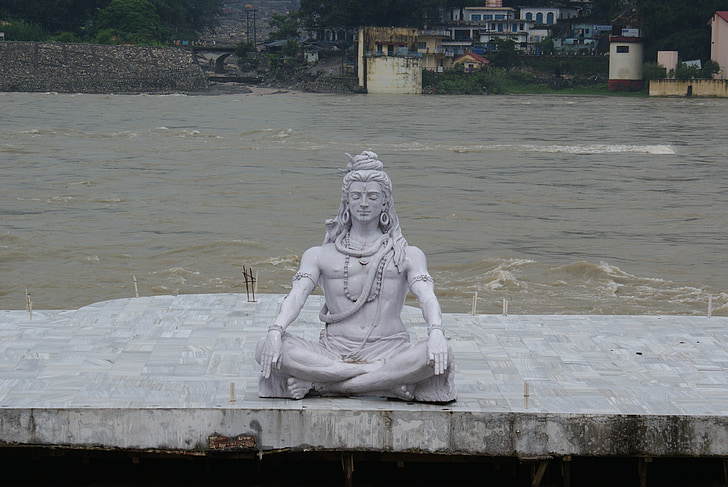 male statue near body of water