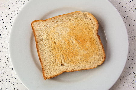 closeup photo of toasted bread with butter spread
