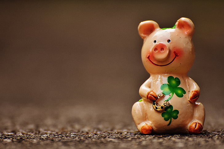 pink ceramic pig figurine smiling