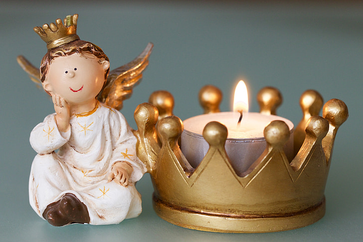white dressed angel and crown figurine