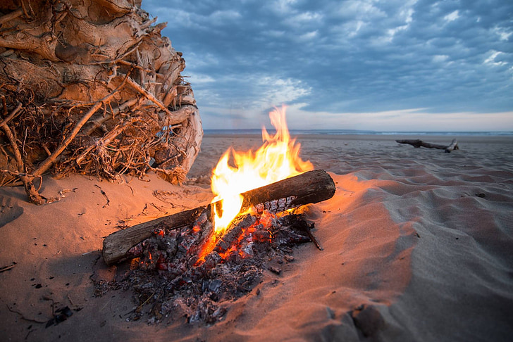 bonfire near sea at golden hour