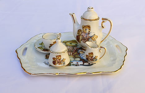 white ceramic teapot set in tray