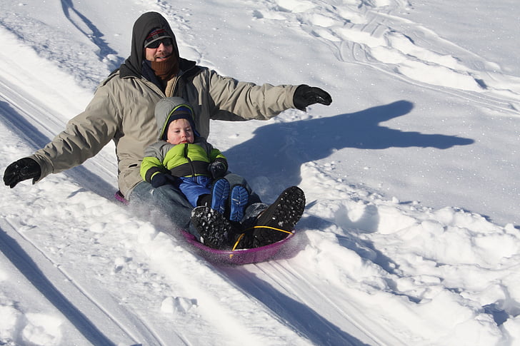 snowboarding man and toddler during daytime