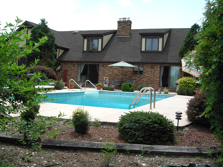 brown house with swimming pool