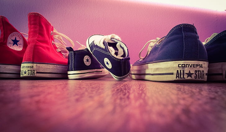 close-up photo of three assorted-color Converse All-Star shoes