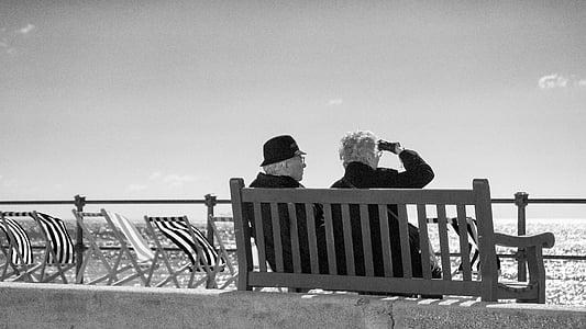 grayscale photo of man and woman sitting