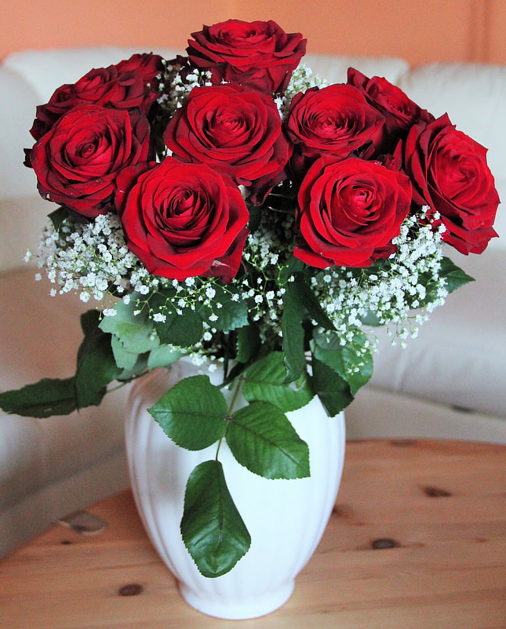 red rose arrangement on white vase
