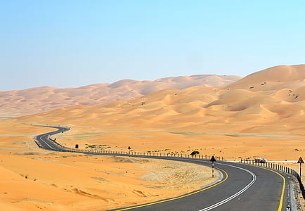 empty curved road in the middle of desert