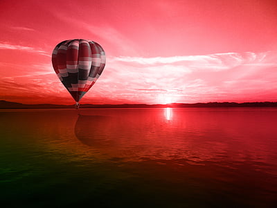 hot air balloon floating above water
