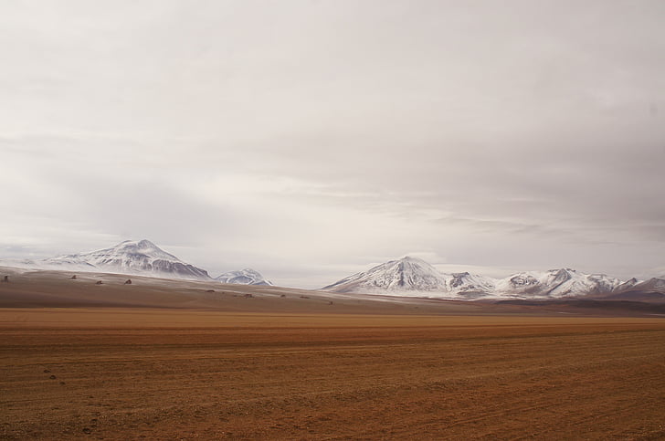 desert against snow-capped mountain