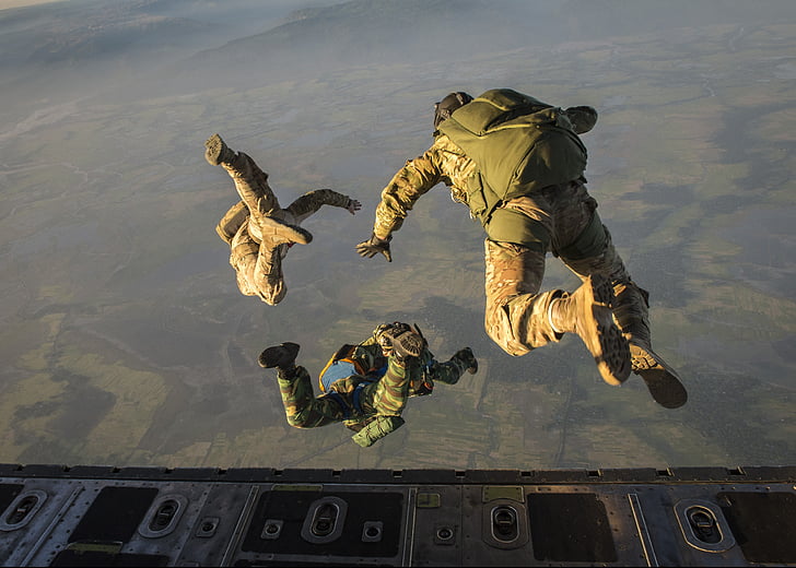 army jumping off plane with parachute backpack