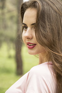 selective focus photography of woman wearing pink shirt with red lipstick