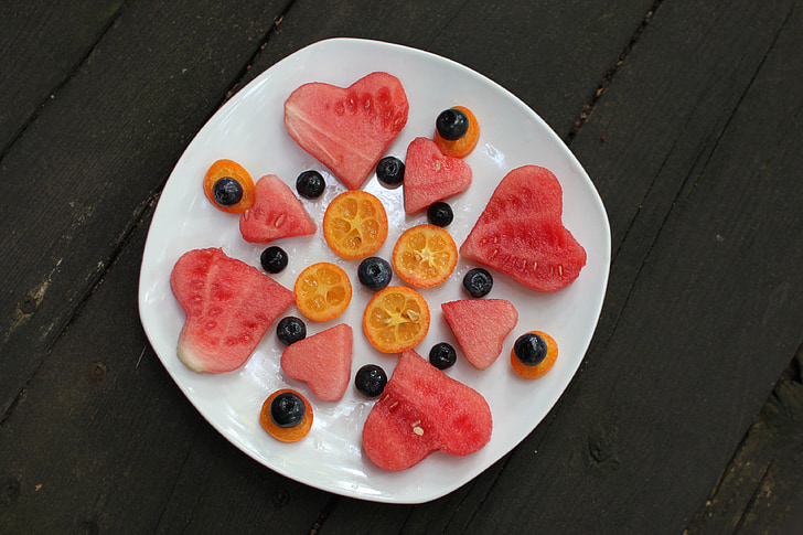 sliced watermelon and orange fruits with olives