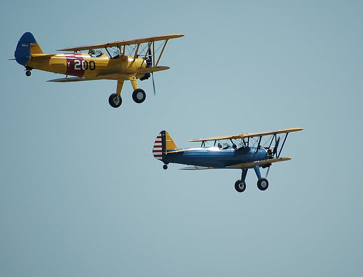 two yellow and blue bi planes