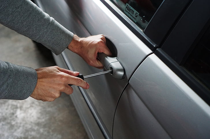person unlocking car door handle
