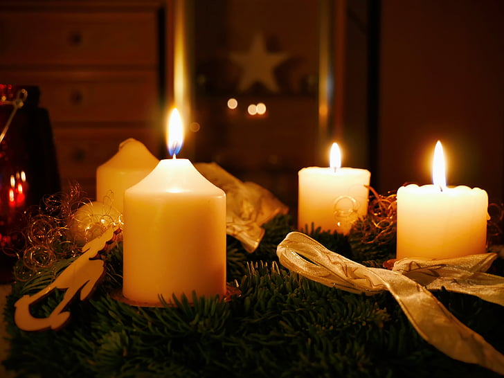 three white lighted candles