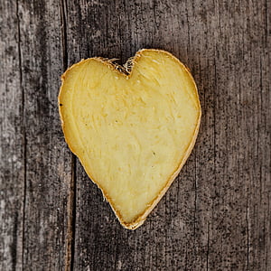 heart-shaped ginger root on brown wooden surface
