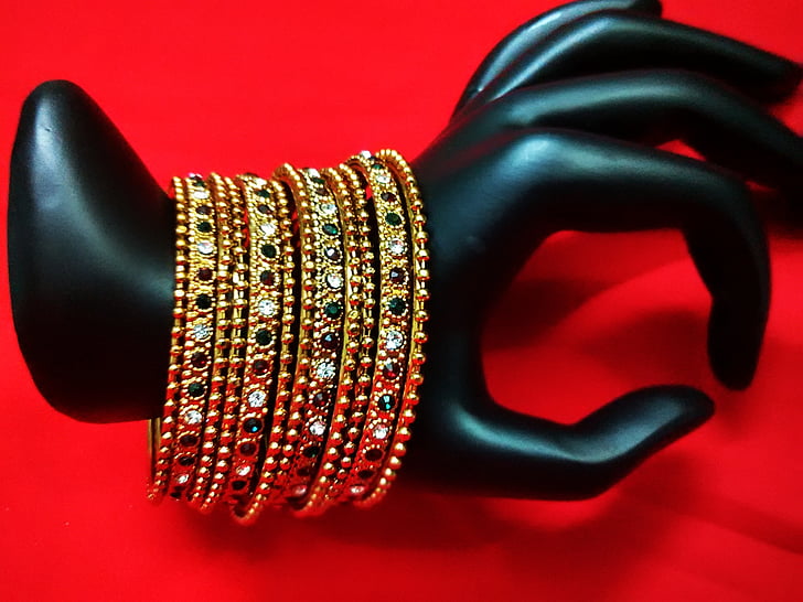 gold-colored bangles with assorted-color gemstones