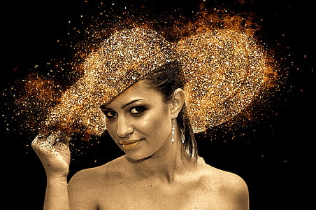 woman holding gold glitter her hat