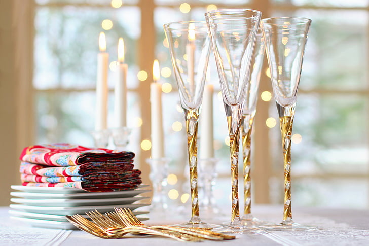 shallow focus photography of gold-colored forks and crystal clear champagne glasses