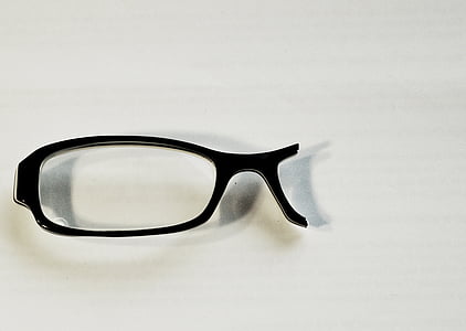 broken black framed eyeglasses