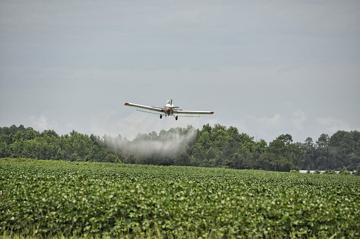 white monoplane spraying fertilizer