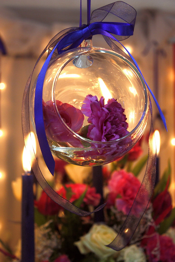 purple flowers in clear glass bowl