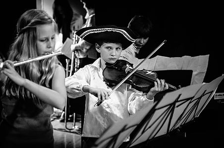 grayscale photo of boy playing violin