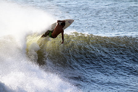 man riding on white surfing board