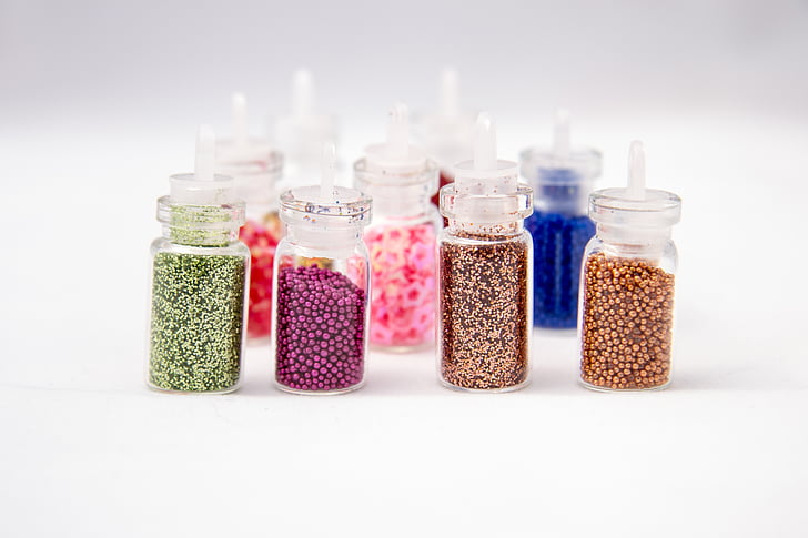 assorted glass bottles with glitter inside