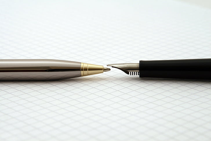 grey ballpoint pen and black fountain pen