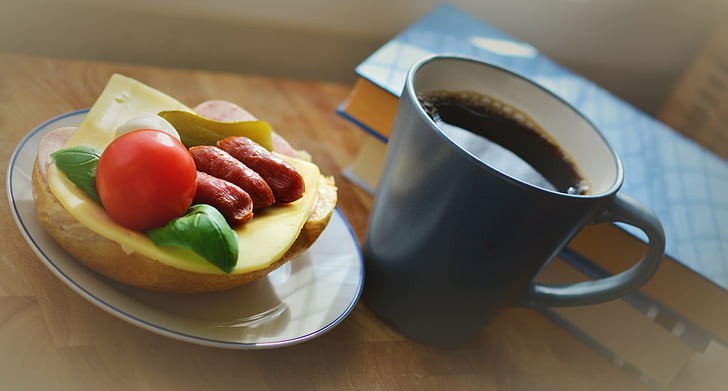 sliced of fruit on plate near black mug