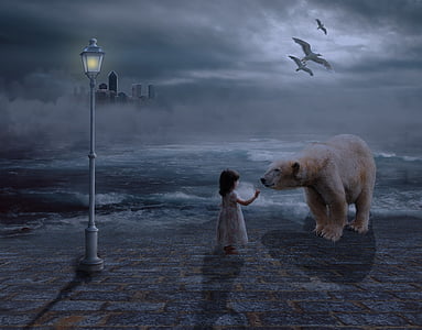 girl holding bear near ocean