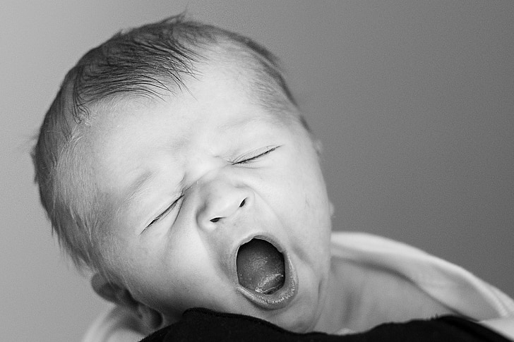 grayscale photo of yawning baby