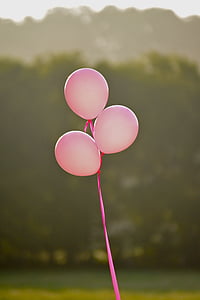 three pink balloons