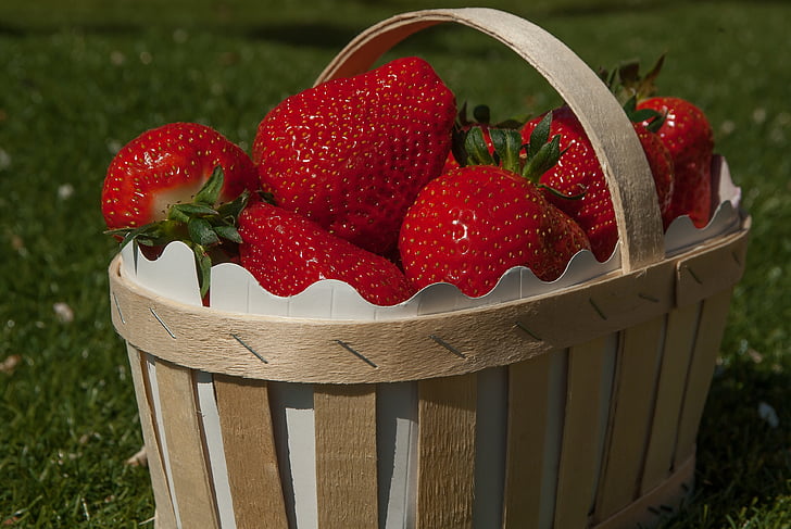 bunch of strawberry on brown basket
