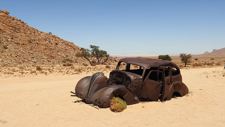 abandoned brown vintage car on desert
