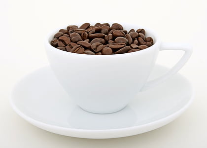 coffee beans on white ceramic coffee cup and saucer