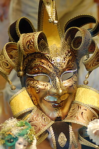 close-up photography of gold floral jester clown mask