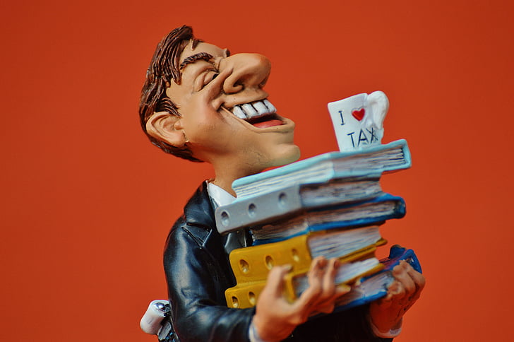 laughing man holding books figurine