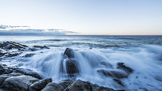 time lapse photo of flowing water on rocks during daytime