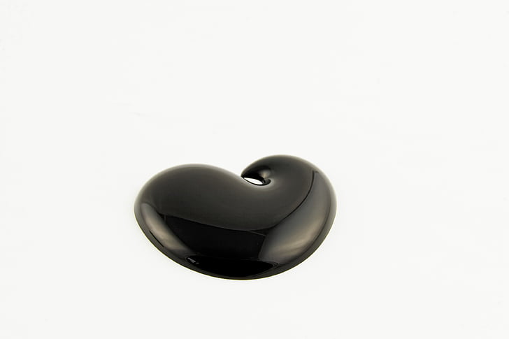 black Bluetooth earpiece against white background