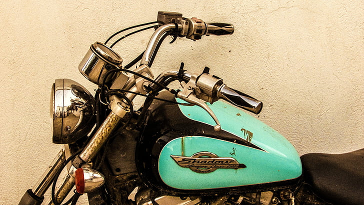 teal and black cruiser motorcycle