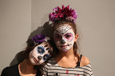 two girl with muerte face paints